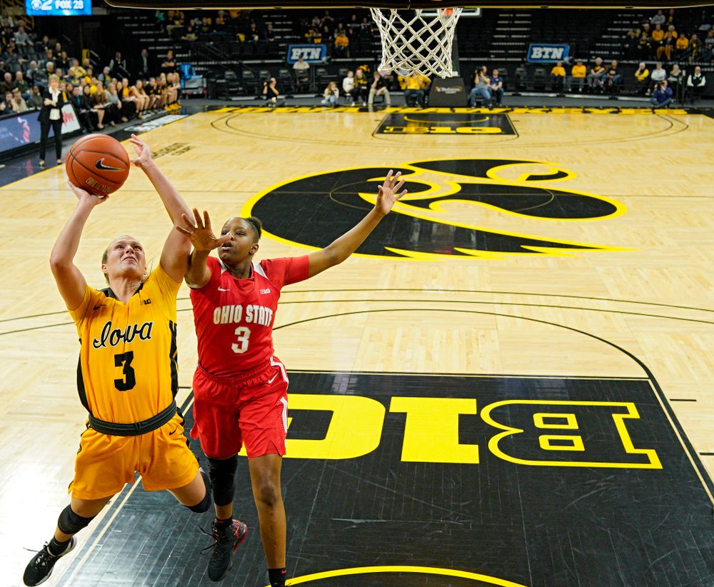 Iowa Hawkeyes guard Makenzie Meyer (3) scores a basket while being fouled by Ohio State Buckeyes guard Janai Crooms (3) during the first quarter of their game at Carver-Hawkeye Arena in Iowa City on Thursday, January 23, 2020. (Stephen Mally/hawkeyesports.com)