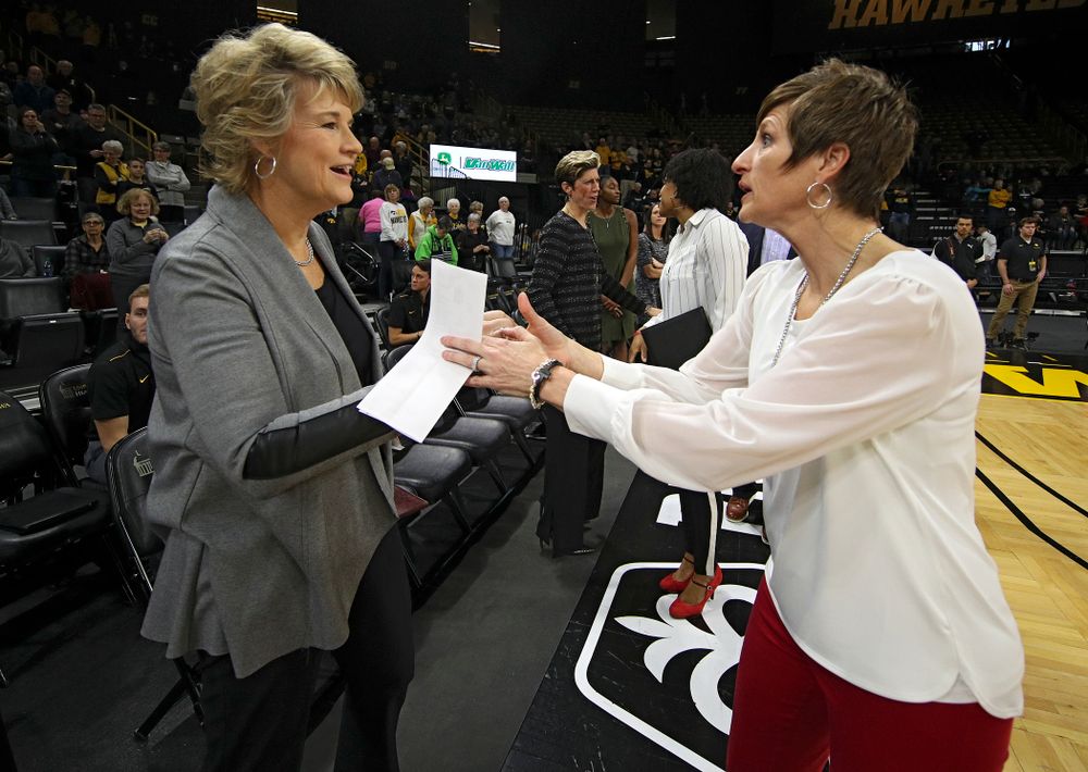 Iowa Hawkeyes head coach Lisa Bluder (from left) shakes hands with Indiana Hoosiers head coach Teri Moren before the start of their game at Carver-Hawkeye Arena in Iowa City on Sunday, January 12, 2020. (Stephen Mally/hawkeyesports.com)