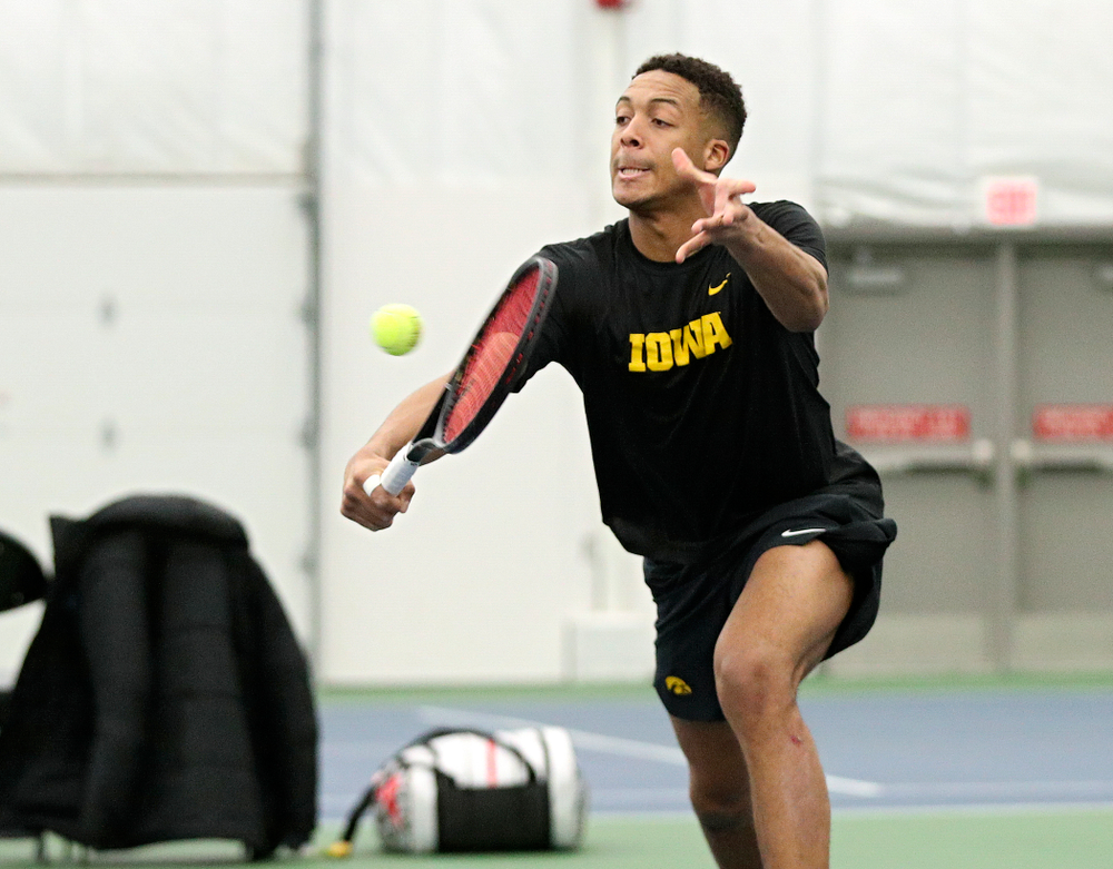 Iowa’s Oliver Okonkwo returns a shot during his doubles match at the Hawkeye Tennis and Recreation Complex in Iowa City on Friday, February 14, 2020. (Stephen Mally/hawkeyesports.com)