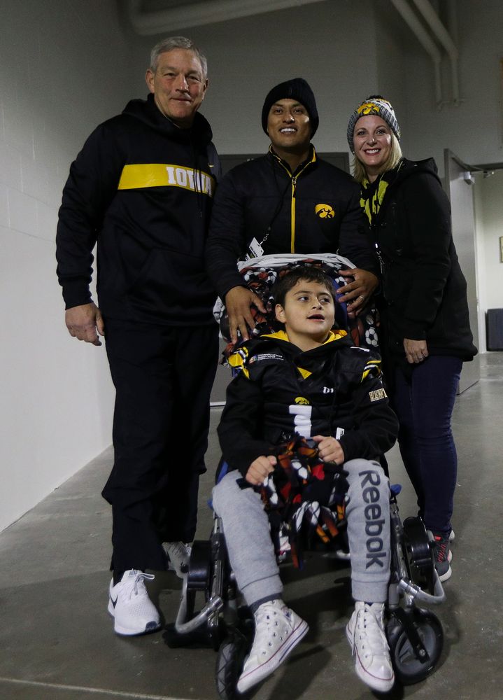 Iowa Hawkeyes head coach Kirk Ferentz poses for a photo with Kid Captain Mason Gonzalez before a game against Northwestern at Kinnick Stadium on November 10, 2018. (Tork Mason/hawkeyesports.com)