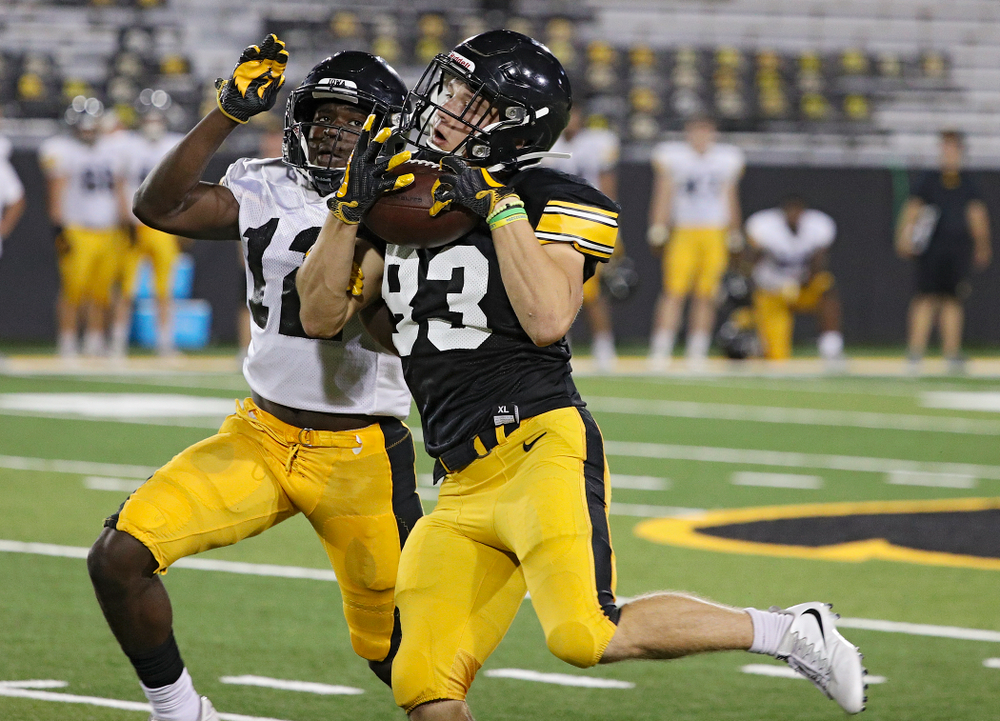 Iowa Hawkeyes wide receiver Alec Kritta (83) pulls in a pass around defensive back D.J. Johnson (12) during Fall Camp Practice No. 12 at Kinnick Stadium in Iowa City on Thursday, Aug 15, 2019. (Stephen Mally/hawkeyesports.com)