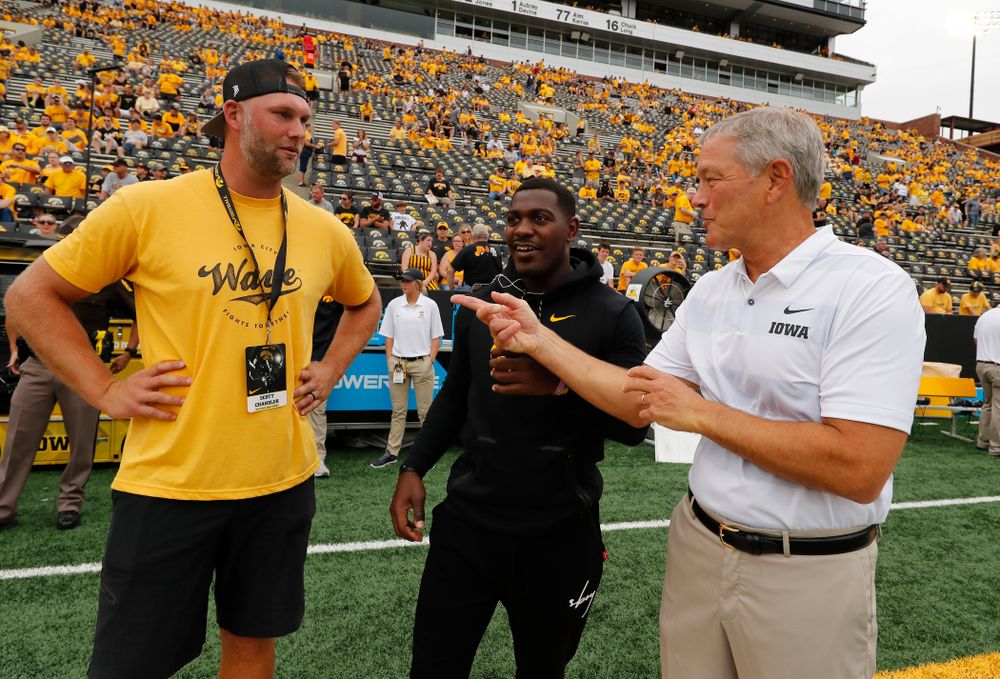 Iowa Hawkeyes head coach Kirk Ferentz talks with former Hawkeyes Desmond King and Scott Chandler before their game against the Northern Illinois Huskies Saturday, September 1, 2018 at Kinnick Stadium. (Brian Ray/hawkeyesports.com)