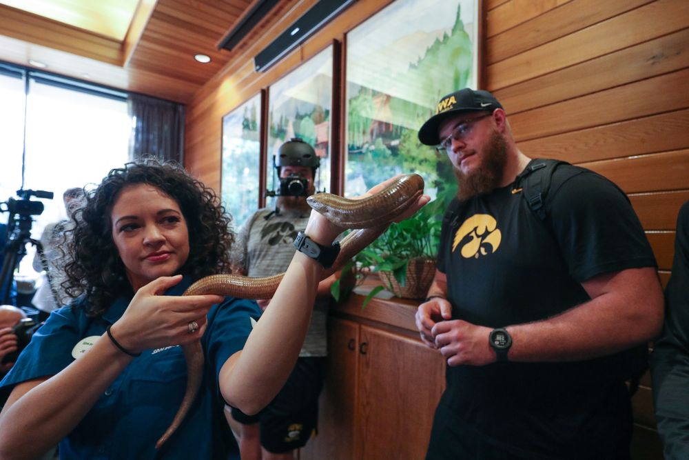 Iowa Hawkeyes offensive lineman Landan Paulsen (68), offensive lineman Levi Paulsen (66), linebacker Nick Niemann (49), and defensive lineman Cedrick Lattimore (95) check out a legless lizard during a trip to the San Diego Zoo Wednesday, December 25, 2019 in San Diego. (Brian Ray/hawkeyesports.com)