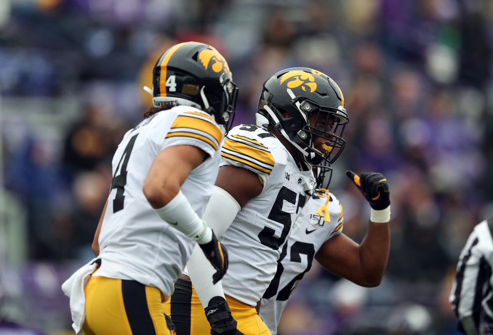 Iowa Hawkeyes defensive end Chauncey Golston (57) celebrates an interception against the Northwestern Wildcats Saturday, October 26, 2019 at Ryan Field in Evanston, Ill. (Brian Ray/hawkeyesports.com)