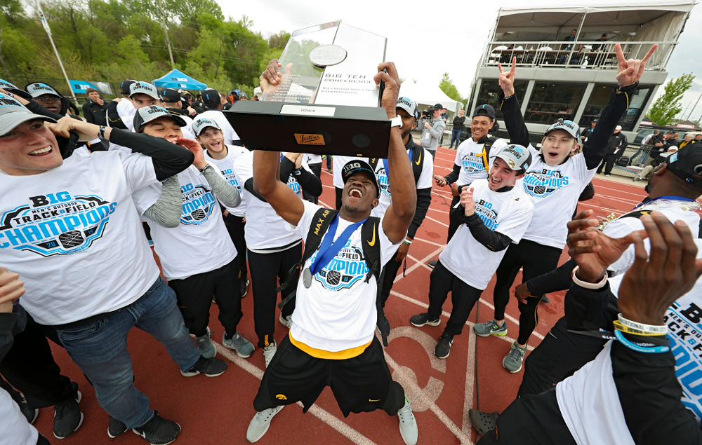 Iowa's Karayme Bartley holds up their team trophy as he celebrates with teammates after winning the Men's Big Ten Outdoor Track and Field Championships on the third day of the Big Ten Outdoor Track and Field Championships at Francis X. Cretzmeyer Track in Iowa City on Sunday, May. 12, 2019. (Stephen Mally/hawkeyesports.com)