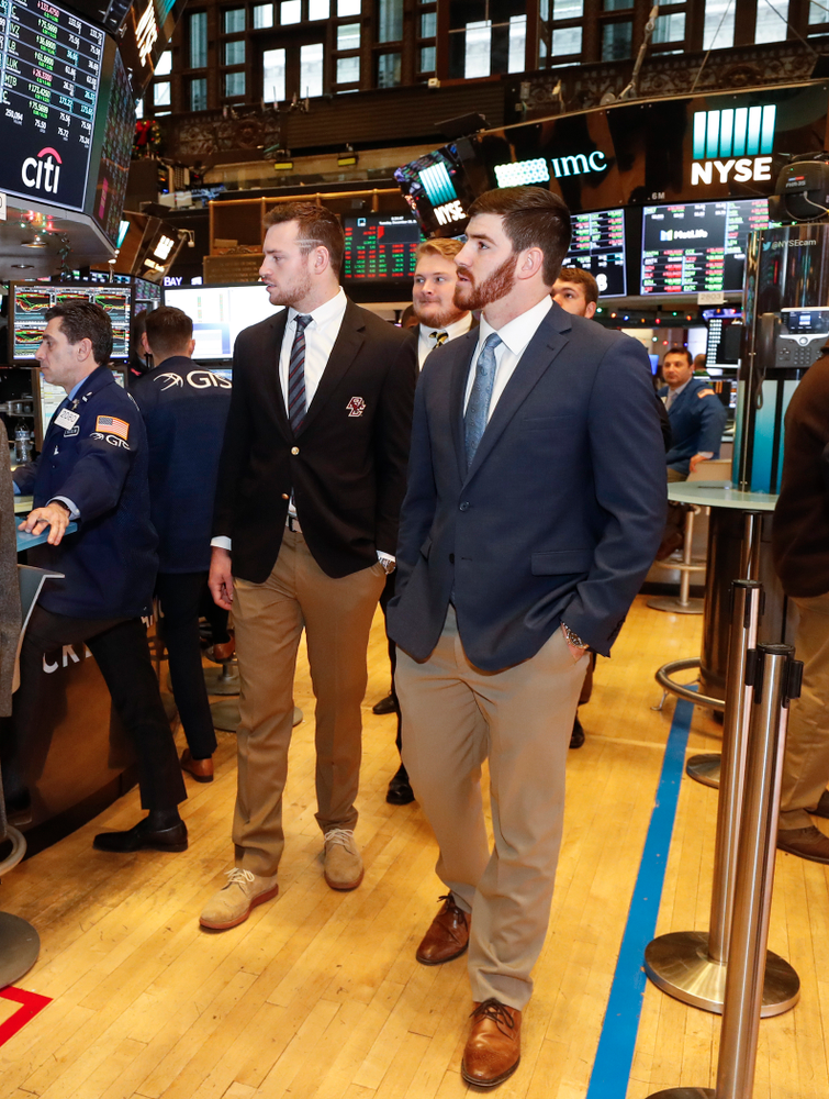 Iowa Hawkeyes linebacker Josey Jewell (43), defensive back Joshua Jackson (15), offensive lineman Sean Welsh (79) and head coach Kirk Ferentz ring the opening bell at the New York Stock Exchange Tuesday, December 26, 2017 in New York. (Brian Ray/hawkeyesports.com)