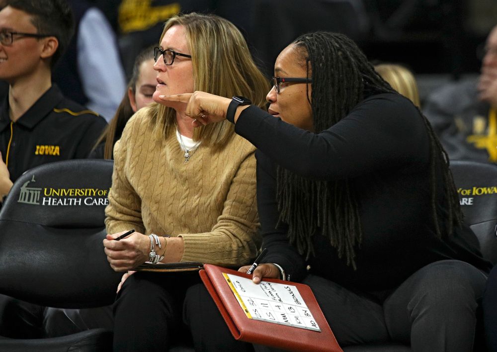 Iowa Special Assistant to the Head Coach Jenni Fitzgerald (from left) talks with assistant coach Raina Harmon during the third quarter of the game at Carver-Hawkeye Arena in Iowa City on Thursday, February 6, 2020. (Stephen Mally/hawkeyesports.com)