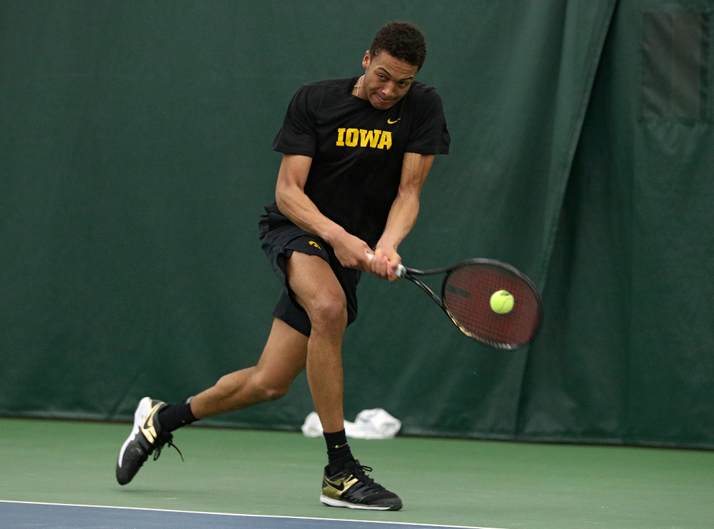 Iowa’s Oliver Okonkwo returns a shot during his singles match at the Hawkeye Tennis and Recreation Complex in Iowa City on Friday, March 6, 2020. (Stephen Mally/hawkeyesports.com)
