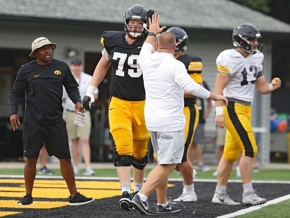 Iowa Hawkeyes offensive lineman Jack Plumb (79) gets a high-five from offensive line coach Tim Polasek durning Fall Camp Practice No. 17 at the Hansen Football Performance Center in Iowa City on Wednesday, Aug 21, 2019. (Stephen Mally/hawkeyesports.com)