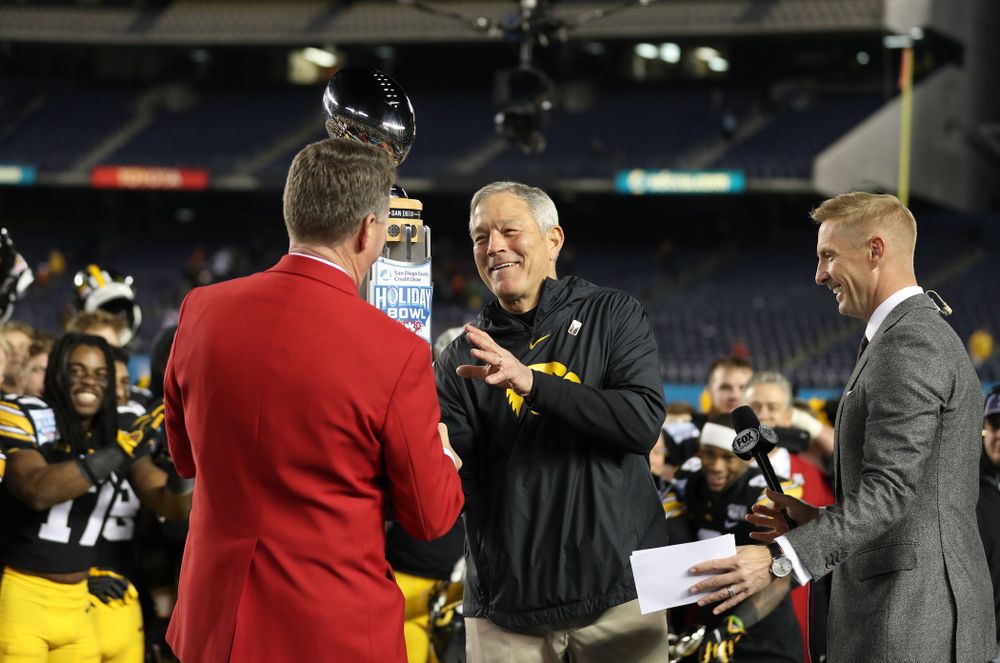 Iowa Hawkeyes head coach Kirk Ferentz is presented with the Holiday Bowl trophy following their win against USC in the Holiday Bowl Friday, December 27, 2019 at San Diego Community Credit Union Stadium. (Brian Ray/hawkeyesports.com)