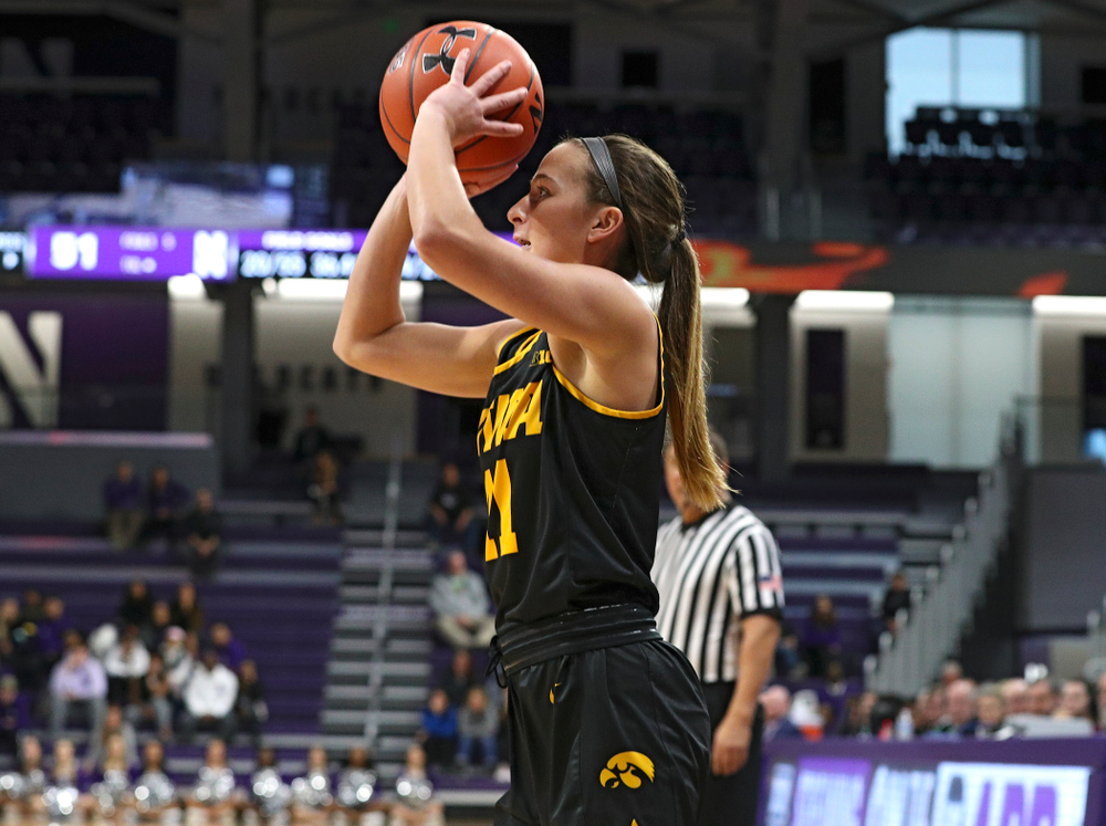 Iowa Hawkeyes guard Megan Meyer (11) makes a 3-pointer during the fourth quarter of their game at Welsh-Ryan Arena in Evanston, Ill. on Sunday, January 5, 2020. (Stephen Mally/hawkeyesports.com)